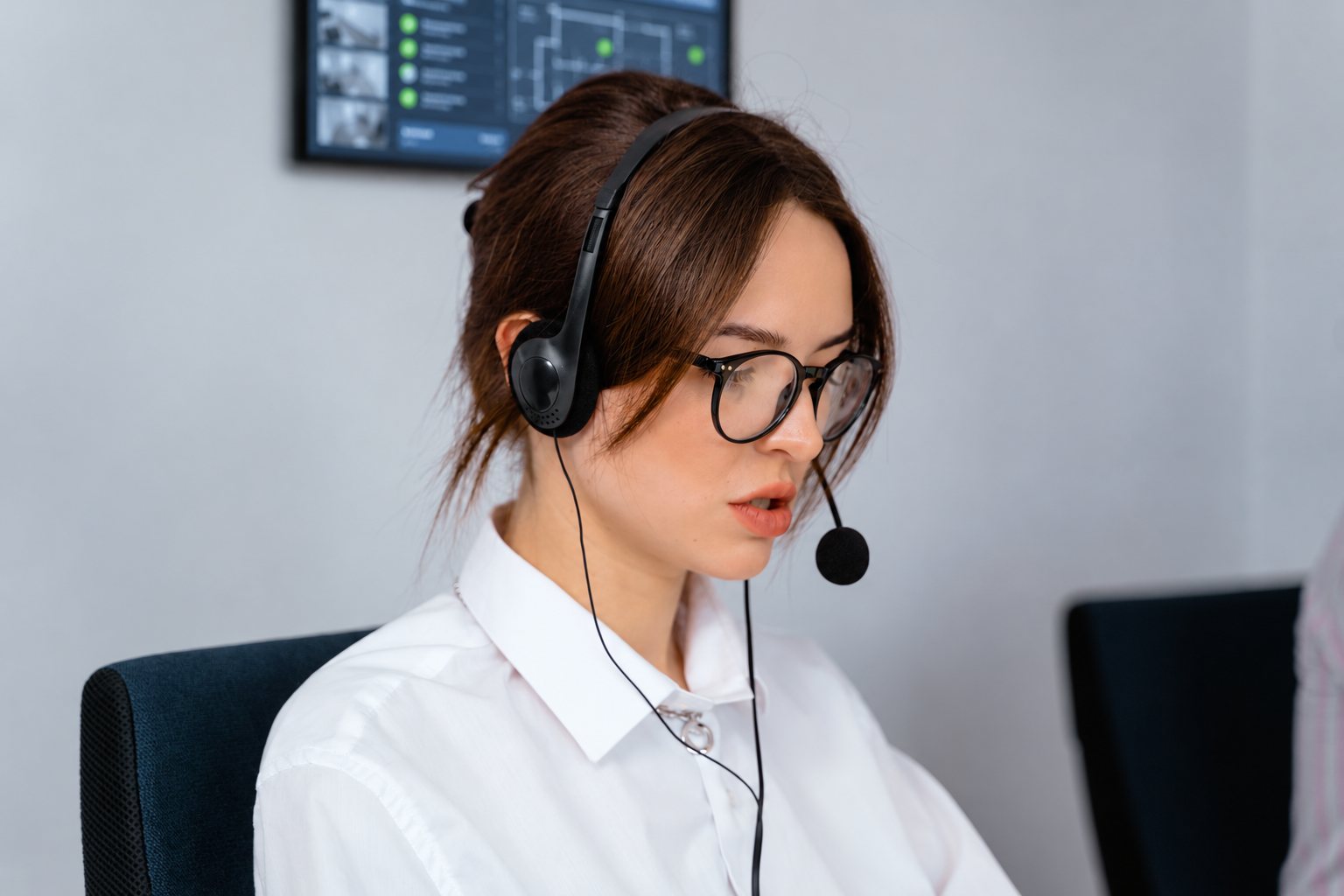 Illustrative stock photo of a headset operator with an edited monitoring display
